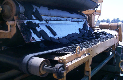 Conveyor loading dewatered biosolids into a trailer