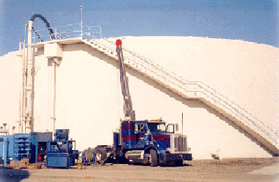Crane and pump equipment staged at a digester